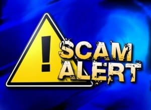 "Sacm Alert" With Caution sign in background | SCAM related to the CARES Act Stimulus Payments | Dalby Wenldand & Co