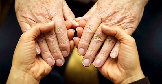 Elderly parents holding hands