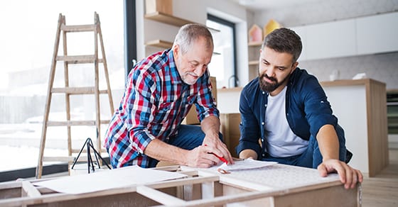 father and adult son looking at home building plans | Unintentional Consequences of Jointly Owning Property with Family Members | Dalby Wendland & Co | CPAs | Business Advisors | Estate Tax Planning | Colorado