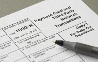 Closeup of Form 1099-K, Payment Card and Third Party Network Transactions, an IRS information return used to report certain payment transactions to improve voluntary tax compliance.