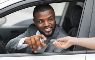 man being handed keys to company car