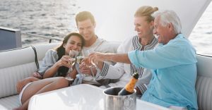 multigeneratonal family making a champagne toast on a boat