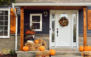 A view of a navy blue house | Fall decorations outside | pumpkins and hay | SALT | OBBBA | DWC CPAs and Advisors | business consulting, tax services, audit and assurance, estate and gift planning, wealth management, bookkeeping, outsourced accounting | Grand Junction CO | Montrose CO | Glenwood Springs CO