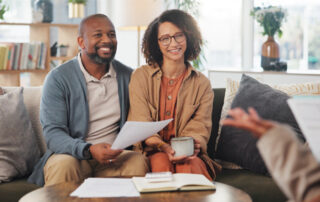 A couple seating on a couch | they are smiling | talking about residuary clause in their will | figuring it out together | DWC CPAs and Advisors | business consulting, tax services, audit and assurance, estate and gift planning, wealth management, bookkeeping, outsourced accounting | Grand Junction CO | Montrose CO | Glenwood Springs CO