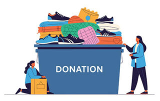 Two people donating clothes and shoes to a donation bin filled with items.