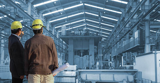 production engineer working in commercial business building with the structural steel structure